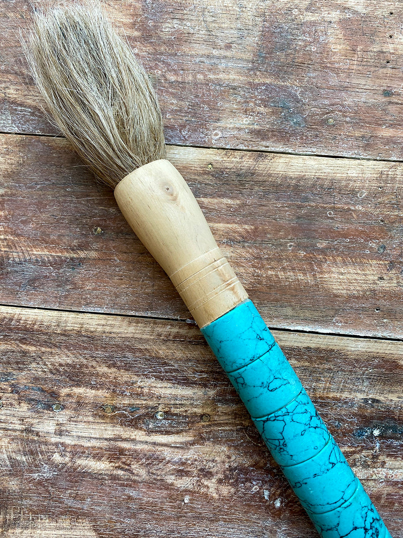 Decorative brush with blue stones and black details