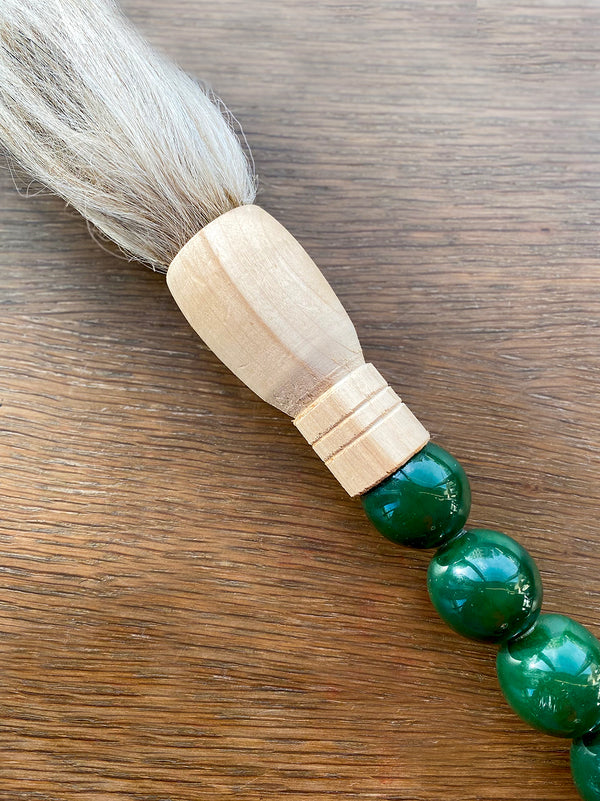 Decorative brush with dark green stones