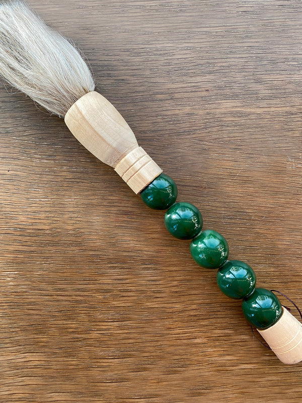 Decorative brush with dark green stones