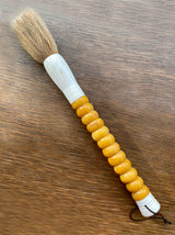 Decorative brush with yellow stones