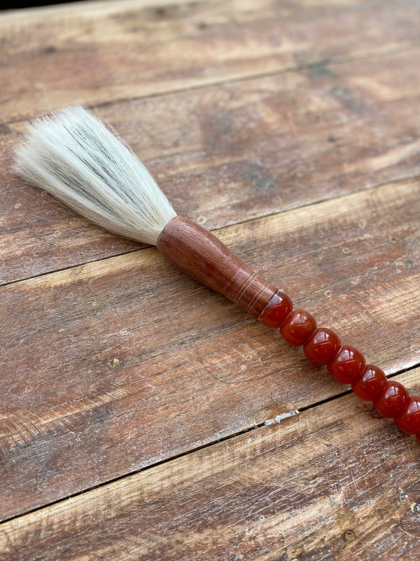 Decorative brush with brown stones