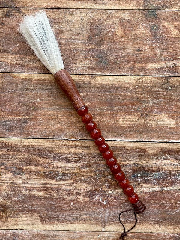 Decorative brush with brown stones