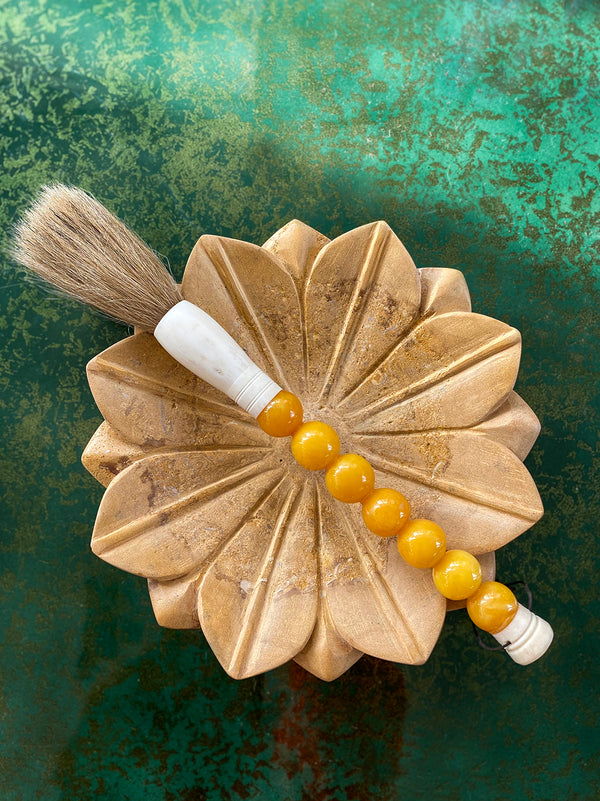 Decorative brush with orange stones