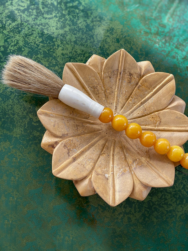 Decorative brush with orange stones