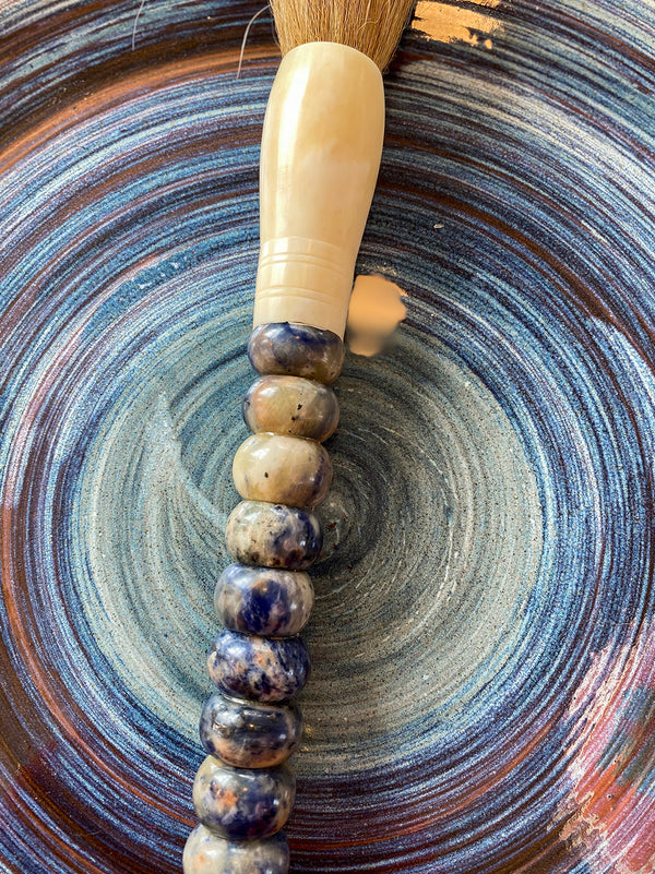 Decorative brush with blue and white stones