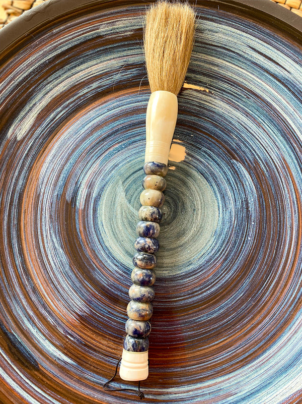 Decorative brush with blue and white stones