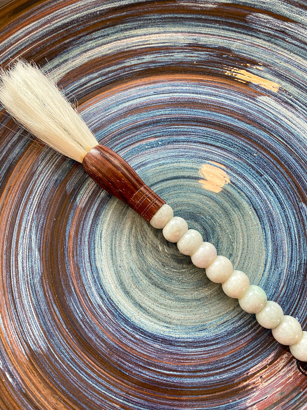 Decorative brush with bluish white stones