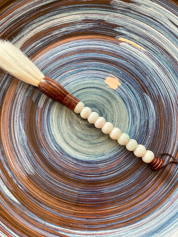 Decorative brush with bluish white stones