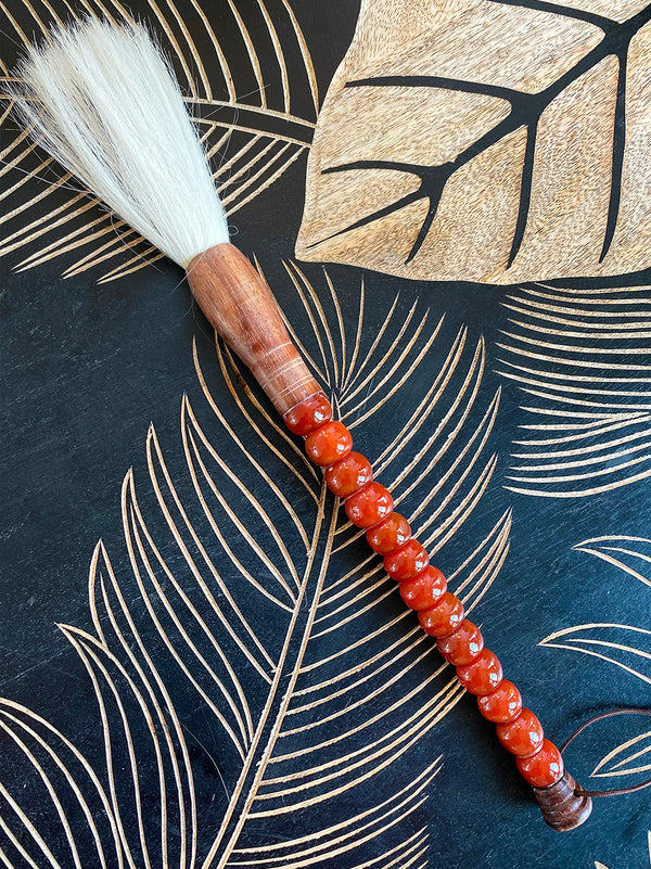 Decorative brush with brownish-red stones