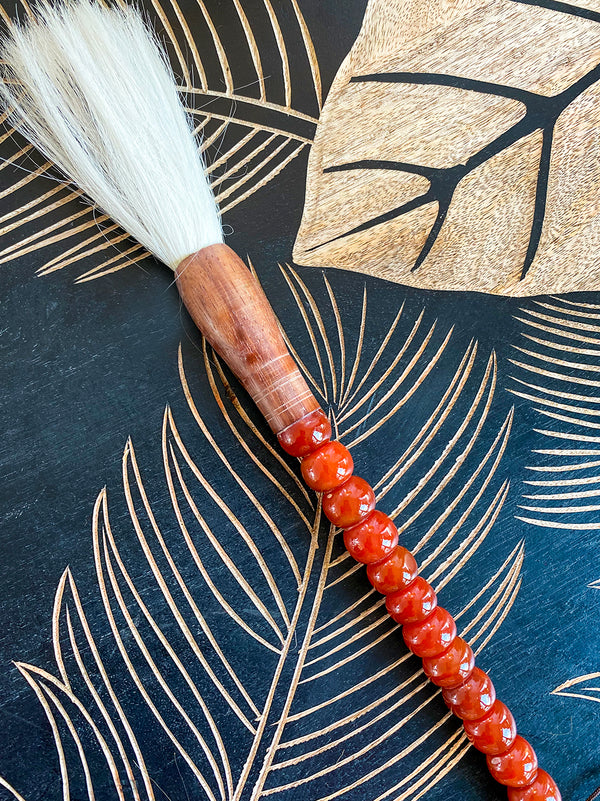 Decorative brush with brownish-red stones